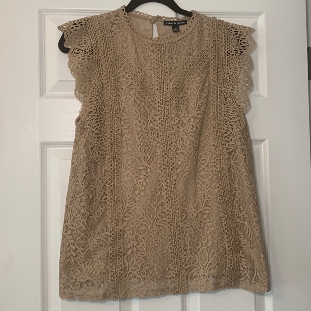 Nude/tan sleeveless lace blouse.
